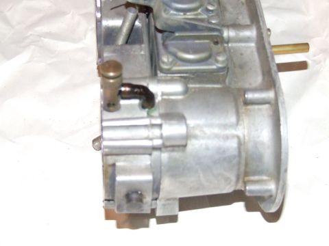 1973 Ford Mustang - Close-up view of a carburetor, showing its metallic components and a small black hose attached.