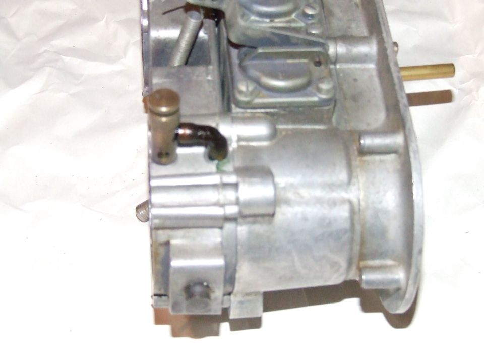 Carburetor with brass fittings and a black hose