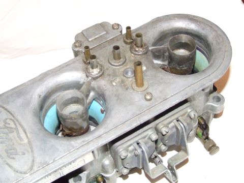 1973 Ford Mustang - Close-up of a Ford carburetor, showing the Ford logo and various fittings.