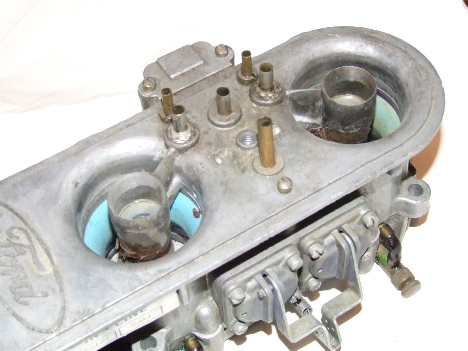 Ford carburetor with visible Ford logo and part numbers