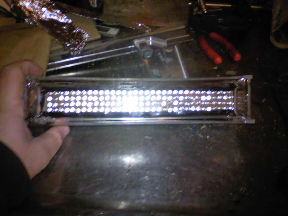 LED light bar with many small bulbs, held by a hand