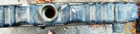 1968 Mercury Cougar - A car radiator sits on the ground, showing signs of wear and tear.