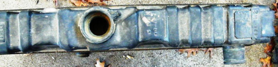 Close-up of a car radiator with some text visible on the side
