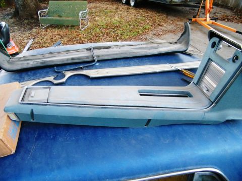 1968 Mercury Cougar - Interior parts, likely from a classic car, are disassembled and placed on a blue surface.