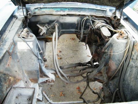 1968 Mercury Cougar - The engine bay of a 1968 Mercury Cougar shows signs of wear and tear, with exposed wiring and rust.