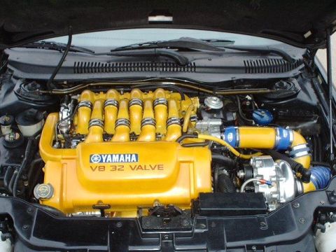 1997 Ford Taurus - Engine bay shows a custom Yamaha V8 engine with prominent yellow intake manifold and turbocharger components.