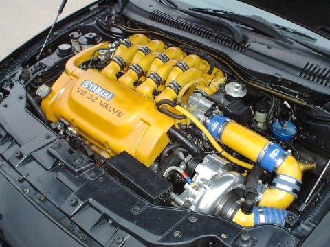 1997 Ford Taurus - Engine bay features a Yamaha V8 32 Valve engine with a prominent turbocharger and bright yellow intake piping.