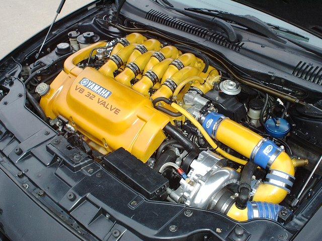Yellow Yamaha V8 32-valve engine bay with blue couplers and boost piping