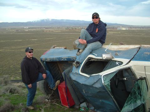 1989 Ford Bronco - Two men sit atop a rolled 1989 Ford Bronco, surveying the landscape.