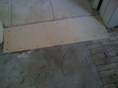 1968 Ford Mustang - A temporary plywood patch is installed over a damaged floor area.