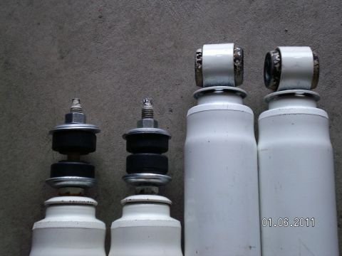 1996 Ford Bronco - Two white shock absorbers are displayed against a gray background, with a date stamp and website logo visible.