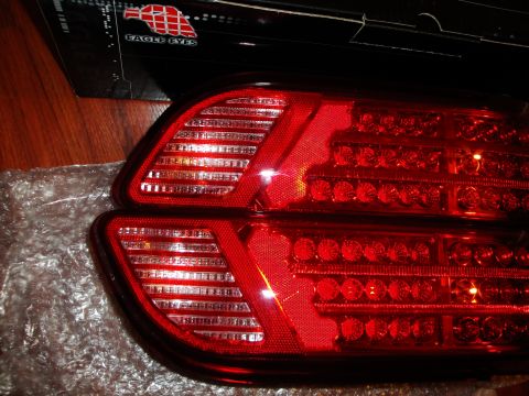 1993 Ford Taurus - Close-up of two red aftermarket LED tail lights, one partially wrapped in bubble wrap.