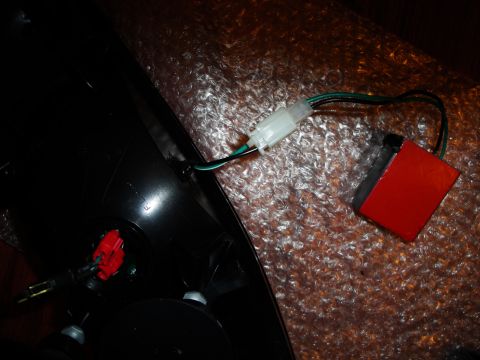 1993 Ford Taurus - Car tail light assembly with wiring and a red electronic component. Year unknown.