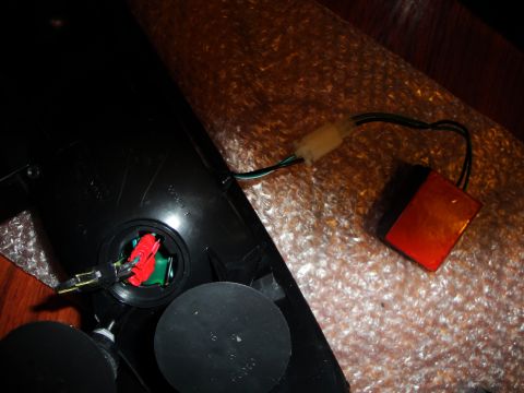 1993 Ford Taurus - The interior of a car tail light assembly shows electrical connectors and a separate amber reflector piece.