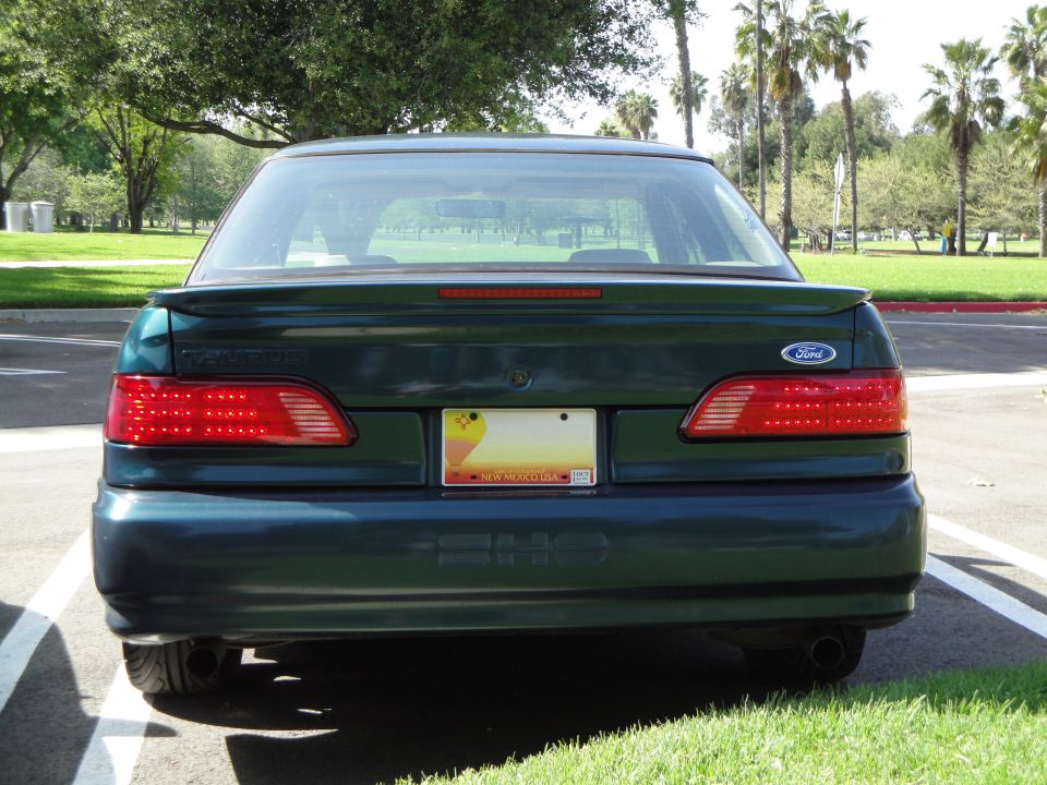 1995 Ford Taurus rear view, dark green paint, New Mexico license plate