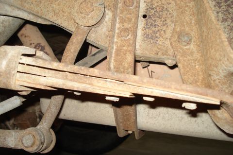 1979 Ford Bronco - The heavily rusted undercarriage shows worn leaf springs and suspension parts.