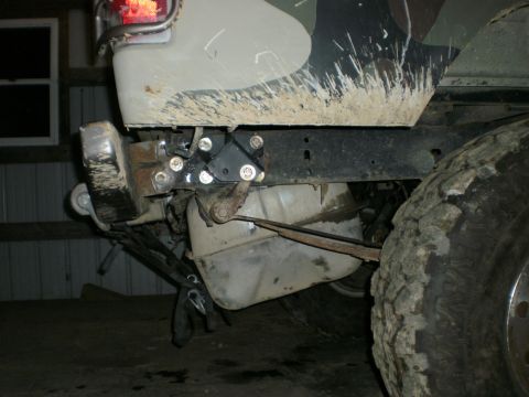 1995 Ford Bronco - The rear axle and fuel tank of a 1995 Ford Bronco are visible, showing custom bracketry for a rear axle swap.