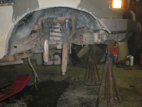 1995 Ford Bronco - The undercarriage of a vehicle is shown with its suspension components and frame visible.