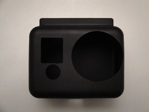 1993 Ford Taurus - A black camera housing with cutouts for the lens and control buttons sits on a plain surface.