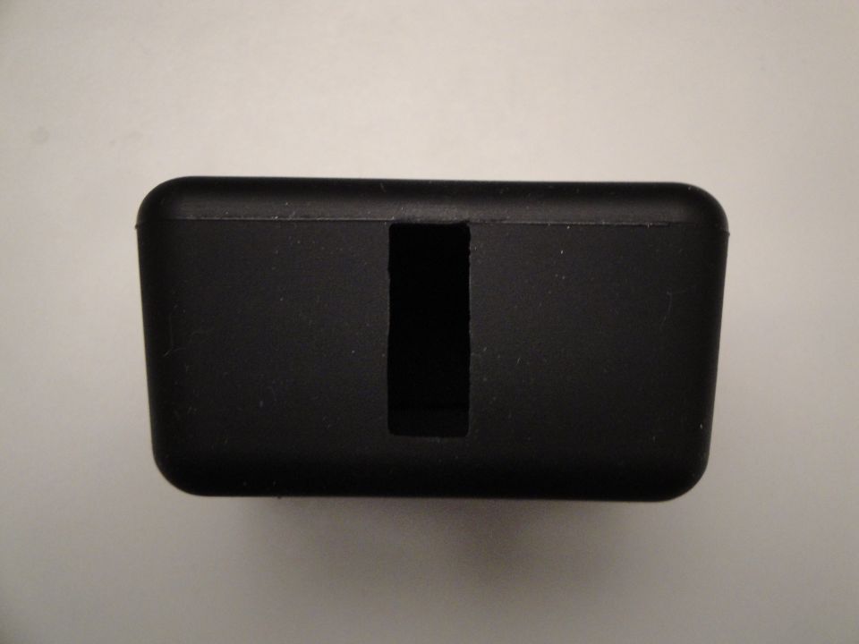 black plastic part with a rectangular slot in the middle