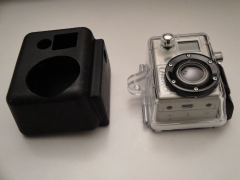 1993 Ford Taurus - An action camera and its protective case are displayed on a flat surface.