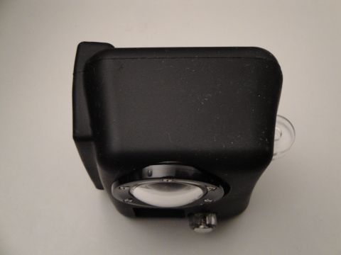 1993 Ford Taurus - A black camera is shown from its side, revealing a clear lens and a small silver knob.