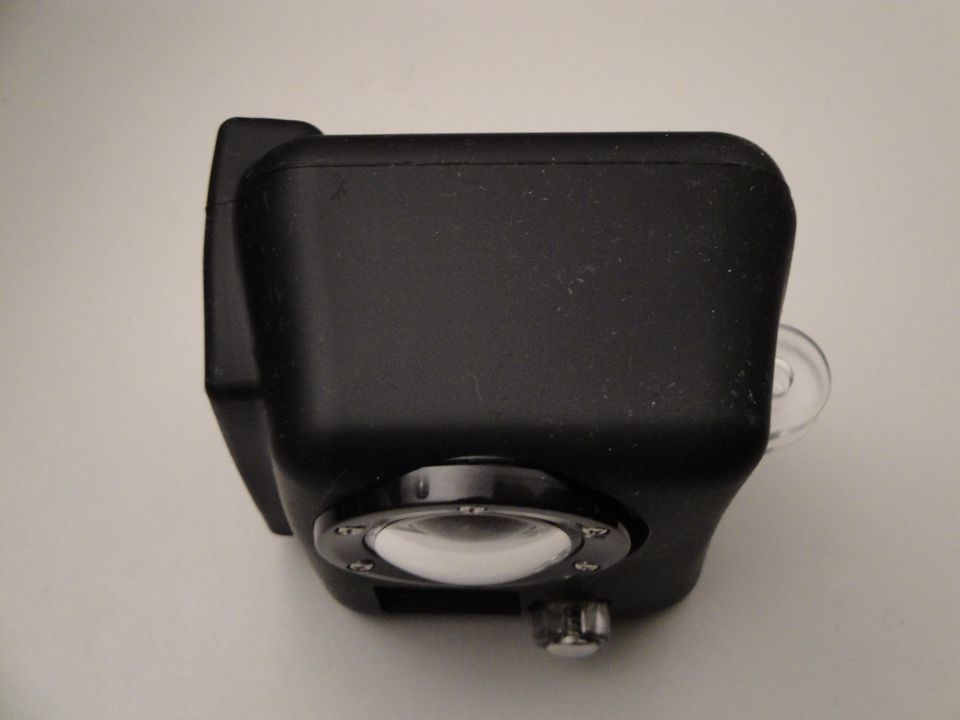 Black camera with a clear lens and silver knob, viewed from the side
