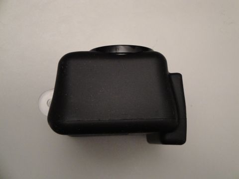 1993 Ford Taurus - A close-up view of a black camera housing, showing its textured surface and a small white attachment loop.