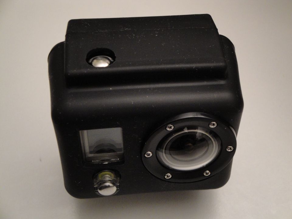 Black action camera with lens and small screen