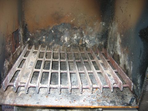1992 Ford Bronco - The interior of a vehicle shows a metal grate and stained walls, suggesting heavy use.