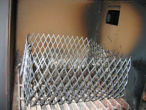 1992 Ford Bronco - Metal mesh guard inside a dark enclosure, possibly part of a heater or exhaust system.