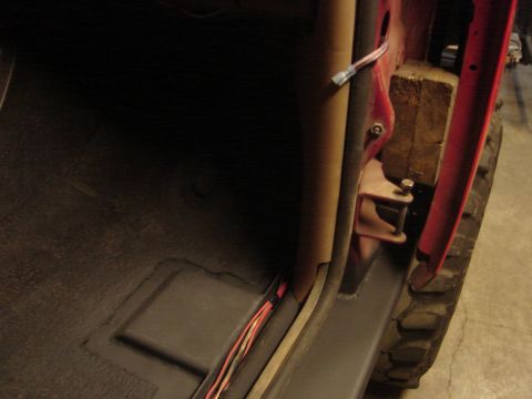 1989 Ford Bronco - Close-up view of the interior door jamb area with exposed wiring and a temporary wooden support.