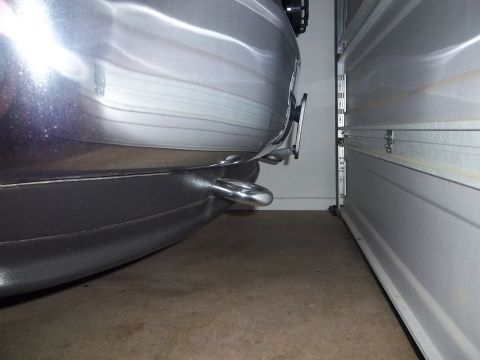 1995 Ford Bronco - The rear of a vehicle is shown parked next to a partially open garage door.