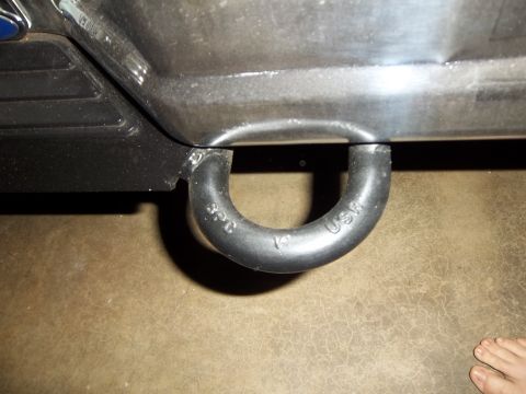 1995 Ford Bronco - A close-up view of a vehicle's tow hook, showing its markings and attachment point.