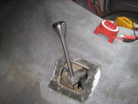 1996 Ford Bronco - Interior view of a vehicle's shifter area, including a battery disconnect switch and a tool.