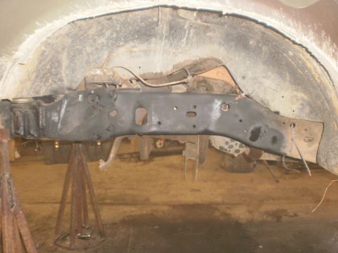 1995 Ford Bronco - Close-up view of a vehicle's undercarriage, focusing on the frame and suspension components.