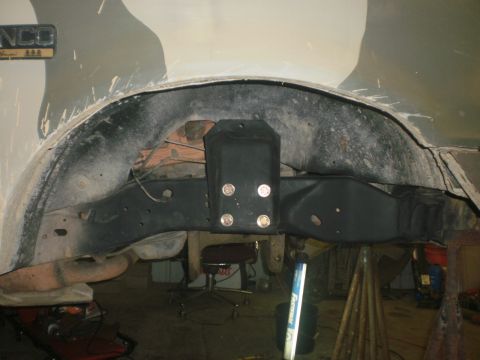 1995 Ford Bronco - This photo shows the underside of a vehicle, focusing on the suspension and frame in the rear wheel well area.