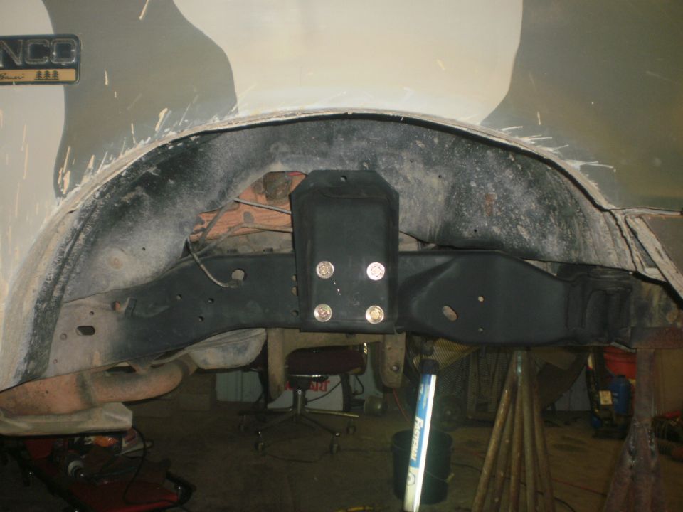 close-up of vehicle's rear wheel well and suspension components, looks like custom work