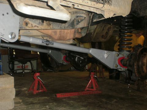 1995 Ford Bronco - Vehicle is on jack stands with aftermarket suspension parts visible on the rear axle.