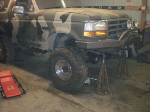 1995 Ford Bronco - This 1995 Ford Bronco is lifted on jack stands, showing its undercarriage and off-road tires.