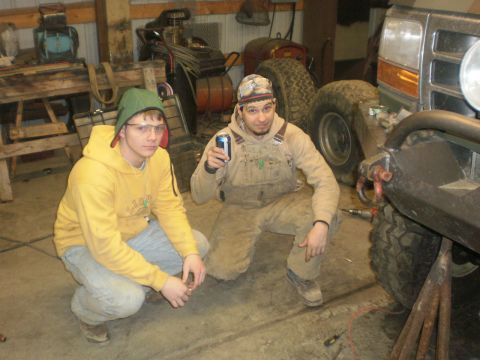 1995 Ford Bronco - Two men in a garage with the front of a 1995 Ford Bronco, which has a custom bumper.