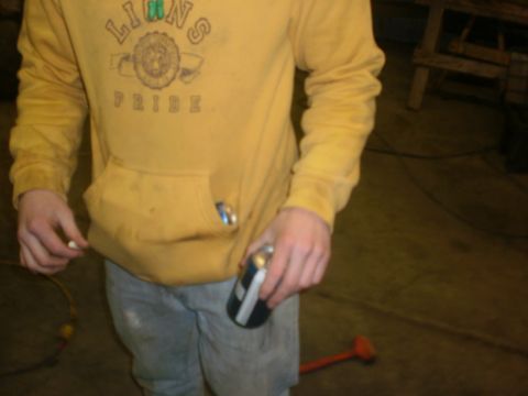 1995 Ford Bronco - A person stands in a workshop, holding a can and a cigarette, wearing a yellow hoodie.
