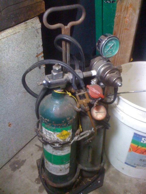 1968 Ford Mustang - Oxygen and acetylene tanks used for welding, with pressure gauges visible.