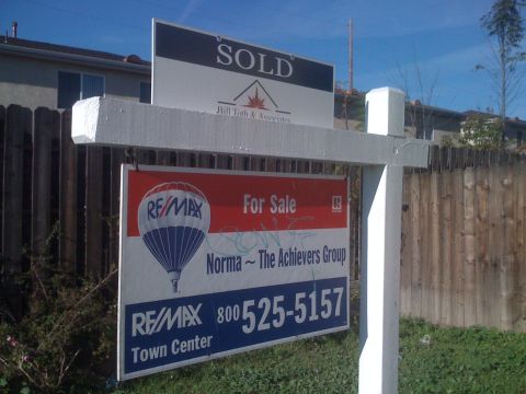 1968 Ford Mustang - Real estate signs indicate a property is sold and another is for sale, with contact information.