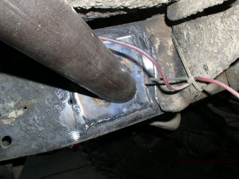 1979 Ford Bronco - Frame repair with wiring visible, focus on the welded section and attached wires.