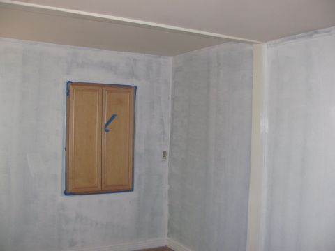 1968 Ford Mustang - Interior room scene with a wooden cabinet on a light blue wall.