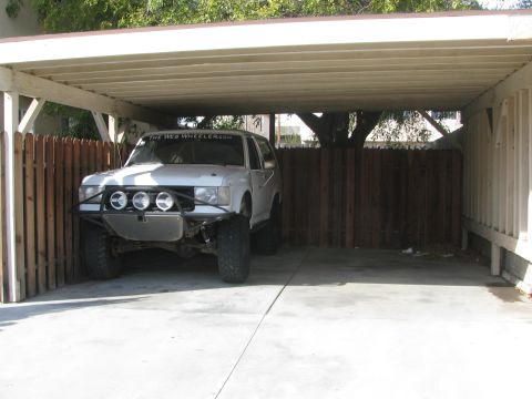 1968 Ford Mustang - This white off-road SUV, possibly modified for desert racing, is parked under a carport. The windshield displays the website 'THE WEB WHEEL…
