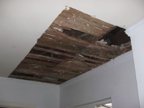 1968 Ford Mustang - The ceiling has a large hole, exposing the wooden structure and insulation above.
