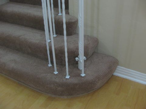 1968 Ford Mustang - Interior view of carpeted stairs with decorative white railings.