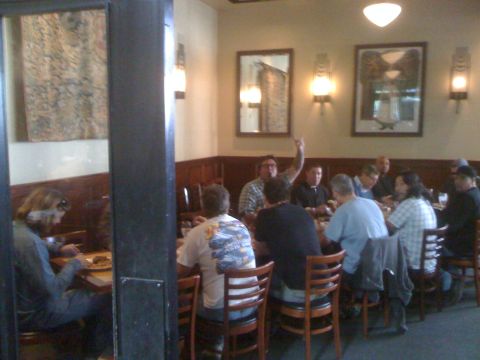 1968 Ford Mustang - People gathered around tables in a restaurant dining area.